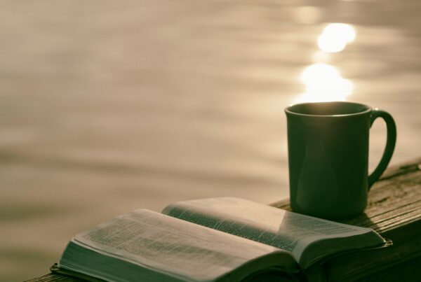 Open book beside a mug of tea, part of a calming evening wind-down routine